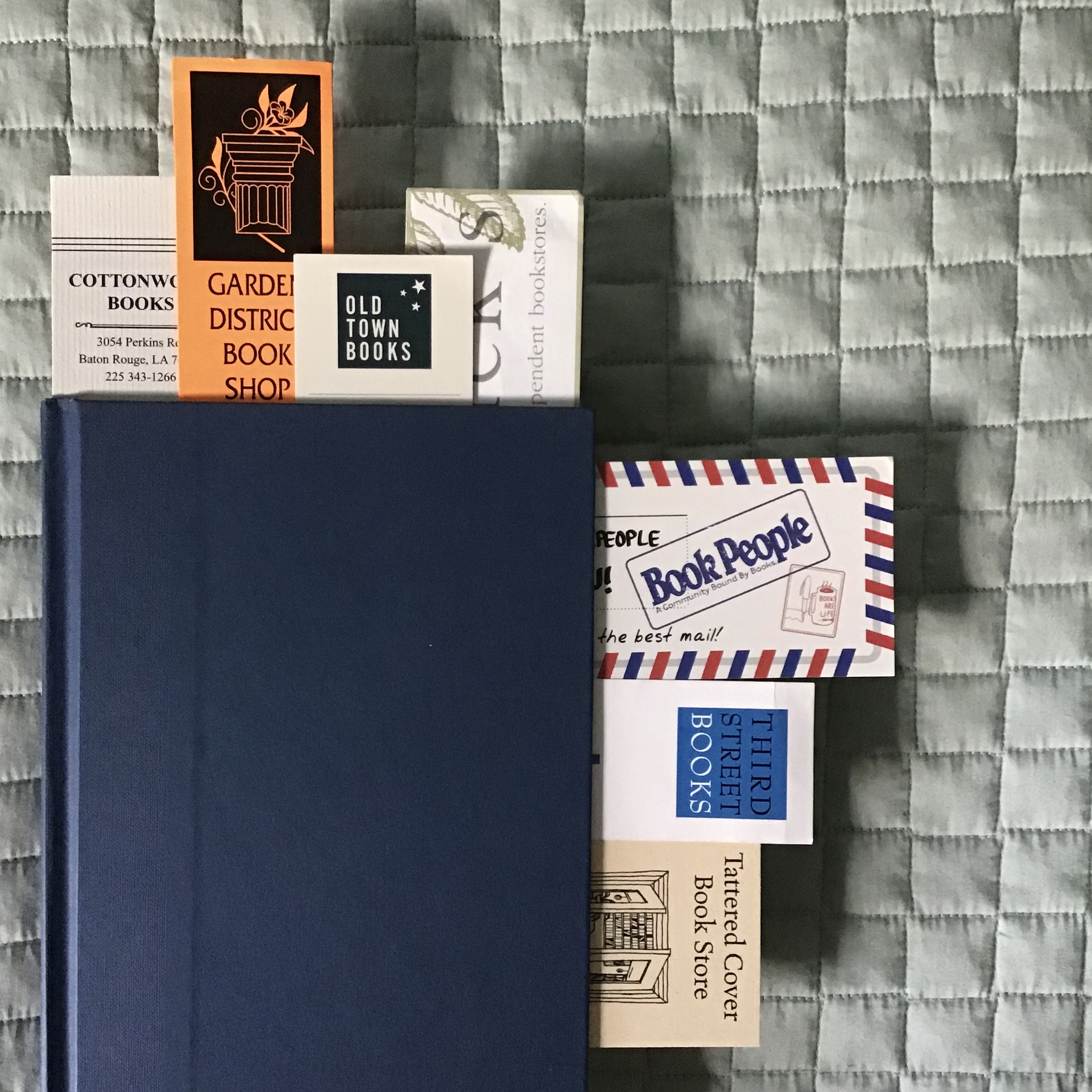 a book with bookmarks from various independent bookstores